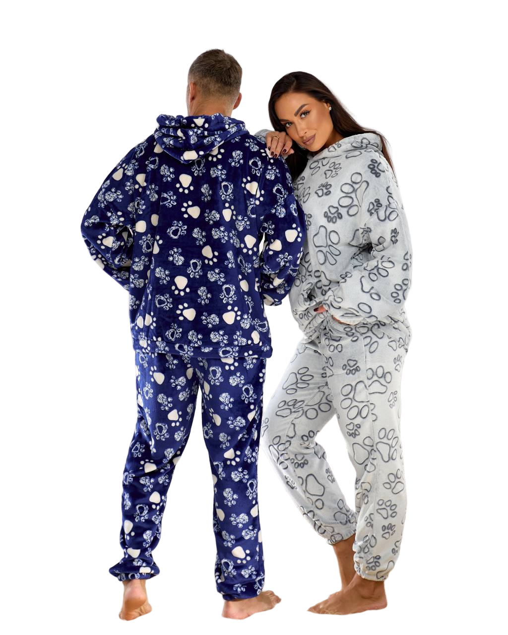 Two people wearing matching floral onesies on a white background