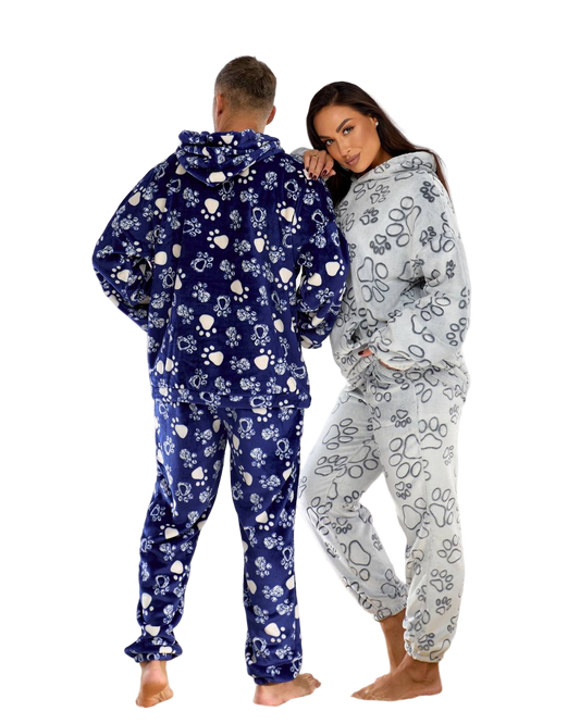 Two people wearing matching floral onesies on a white background