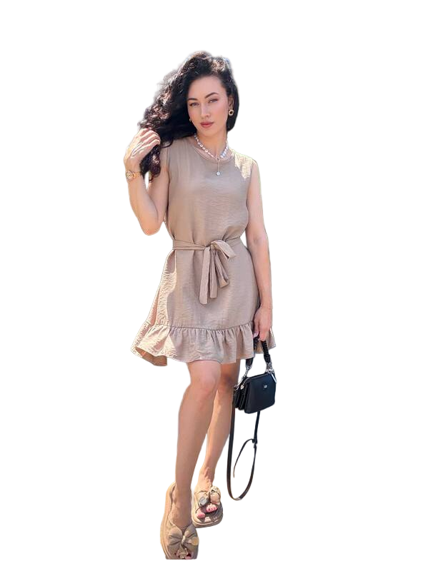 Woman wearing a beige dress holding a black handbag on a white background