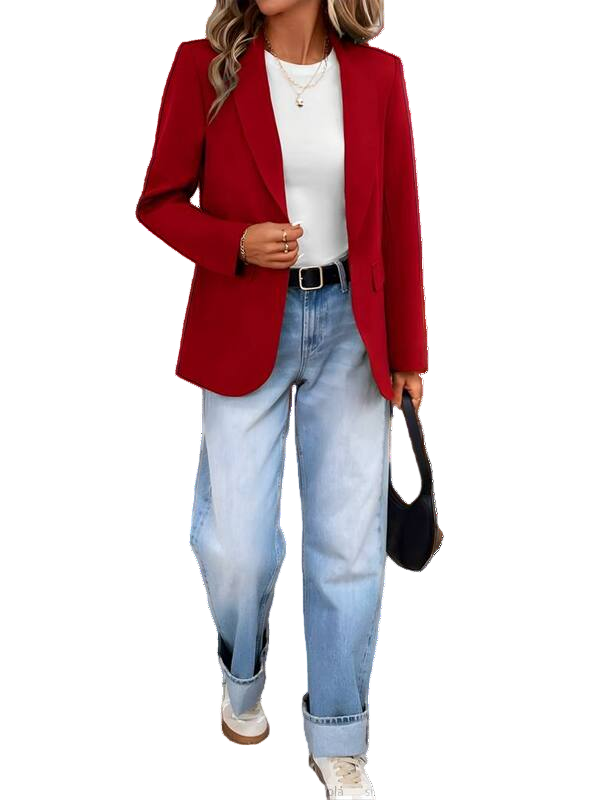 Person wearing a red blazer, white shirt, and blue jeans with a black handbag.