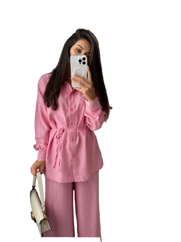 Person wearing a pink outfit taking a mirror selfie.