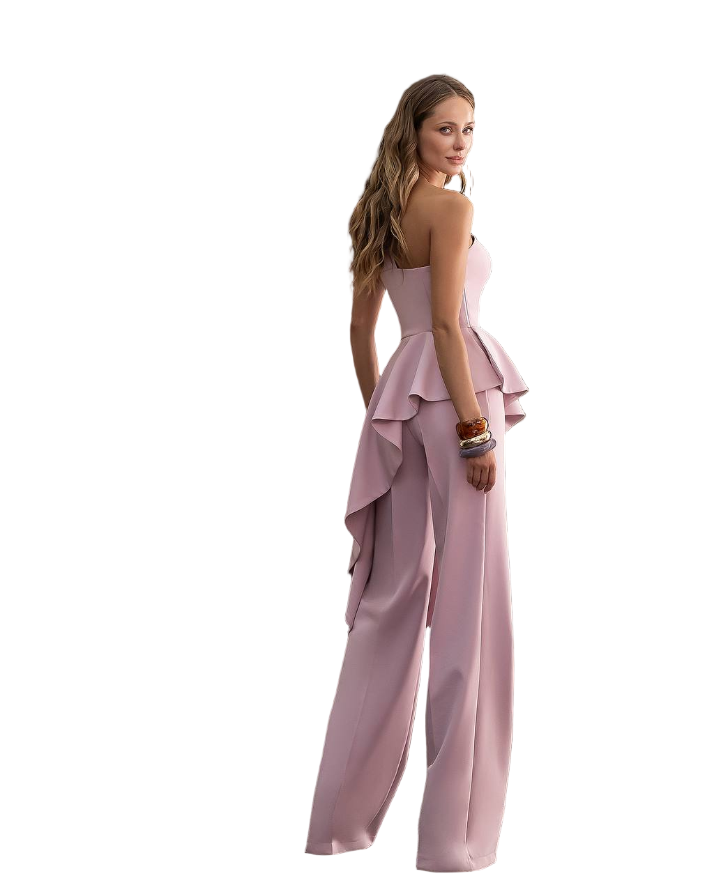Woman wearing a pink ruffled jumpsuit on a white background