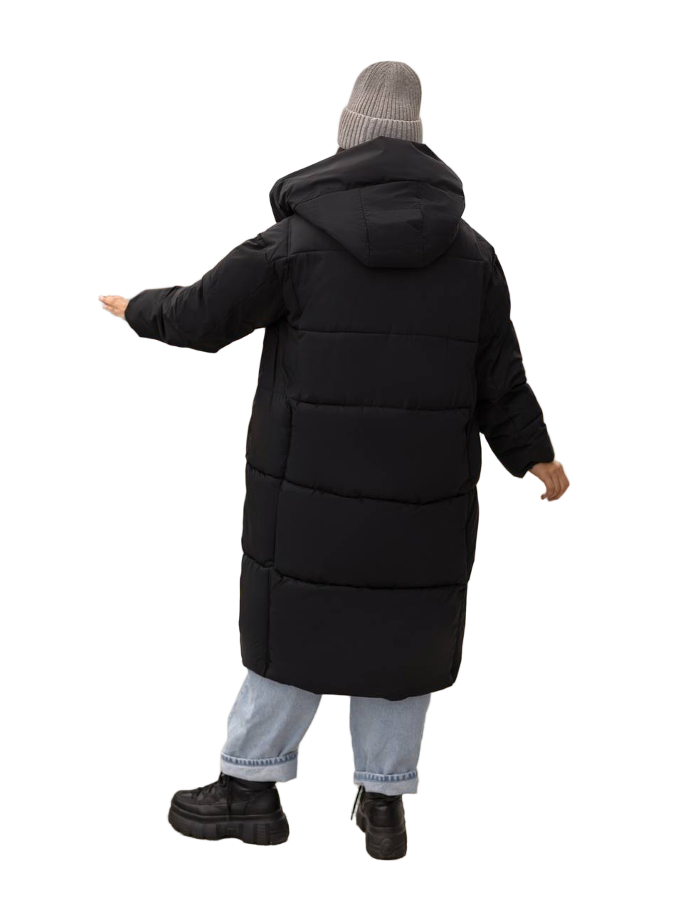 Person wearing a long black puffer coat on a white background