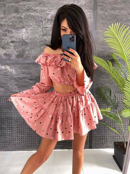 Woman taking a mirror selfie wearing a pink polka dot dress.