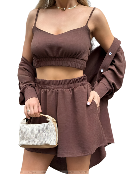 Woman wearing a brown outfit with a matching bag on a white background