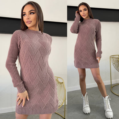 Woman wearing a mauve knitted dress with white sneakers in a minimal indoor setting.