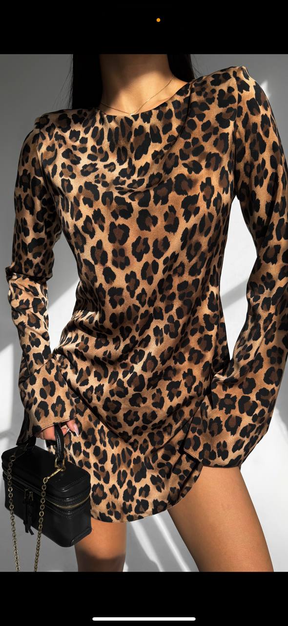 Leopard print dress worn by a person on a plain background