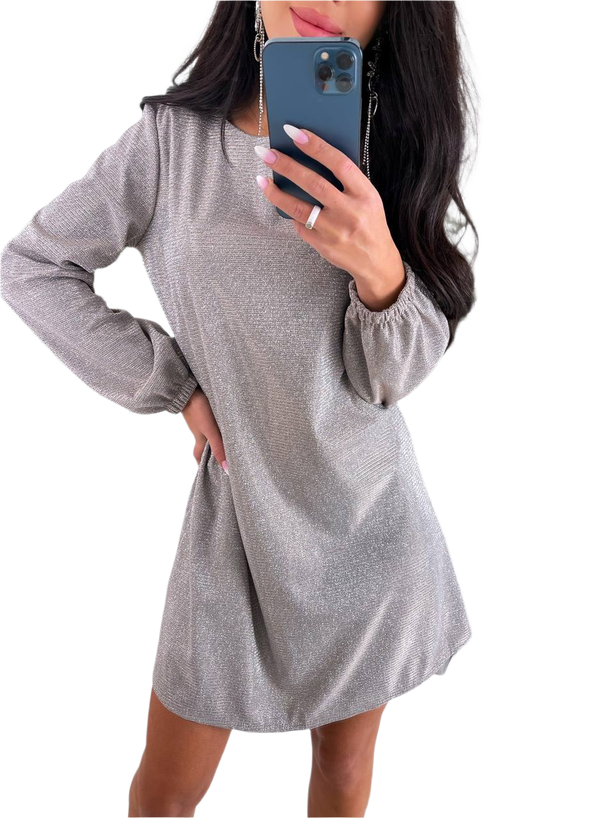 Woman wearing a gray long-sleeve dress holding a phone on a white background