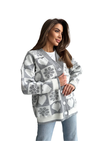 Woman wearing a gray and white patterned cardigan on a white background