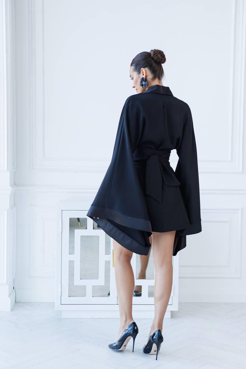 Person wearing a black coat with a white background