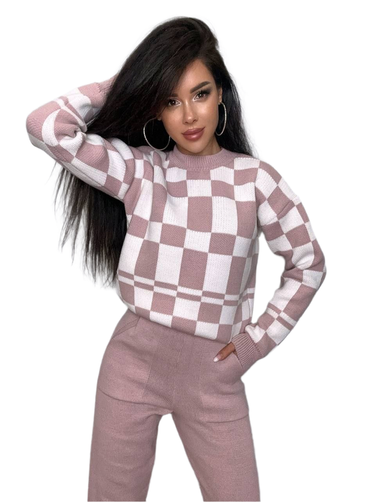 Woman wearing a checkered sweater and pants on a white background