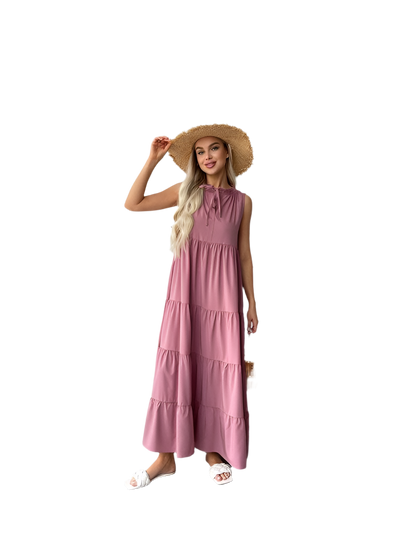 Woman wearing a pink dress and straw hat on a white background