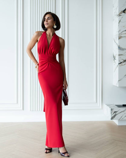 Woman wearing a red dress in an elegant interior setting
