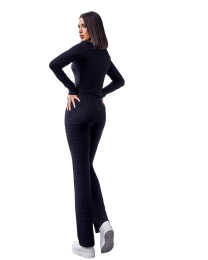 Woman wearing a black outfit on a white background