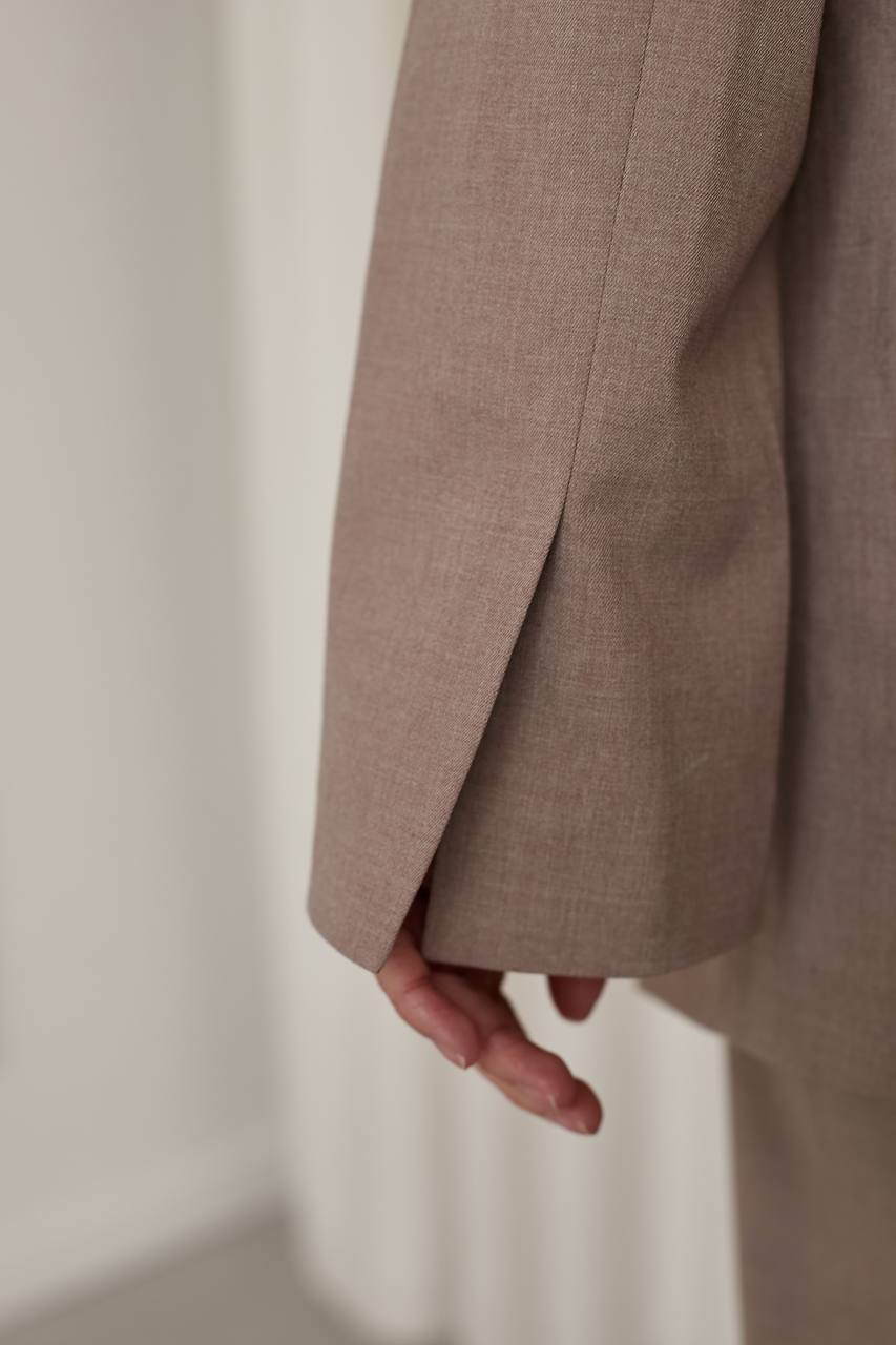 Close-up of a brown coat with a neutral background