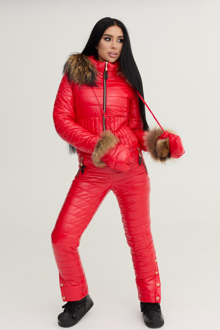 Person wearing a red puffer suit with fur trim on a white background