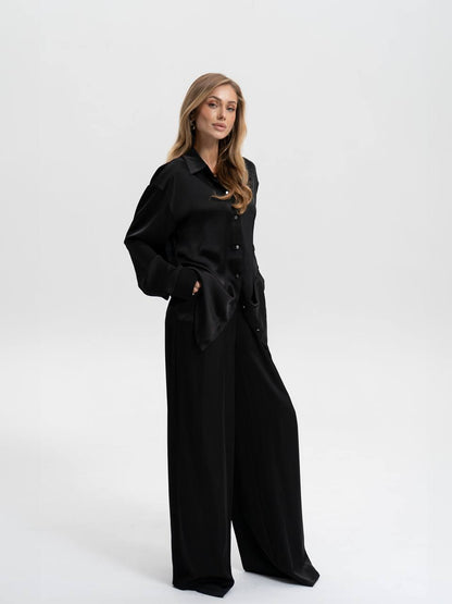 Woman wearing a black outfit on a white background