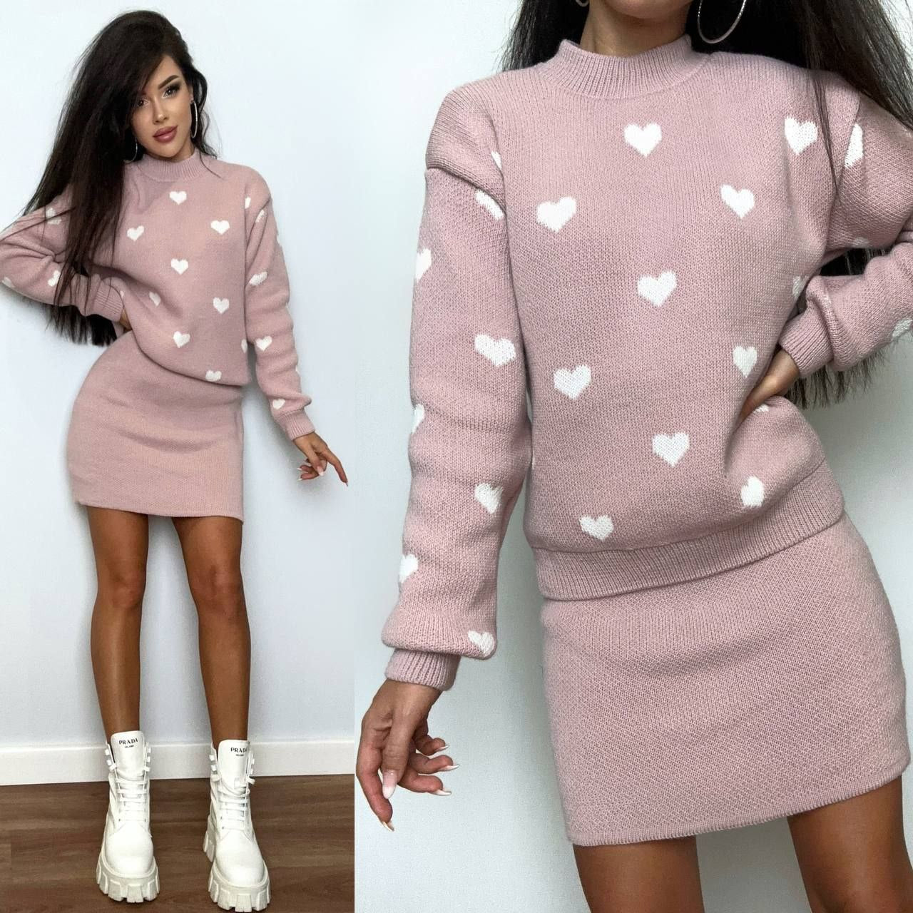 Pink sweater and skirt set with heart patterns worn by a model against a white background.