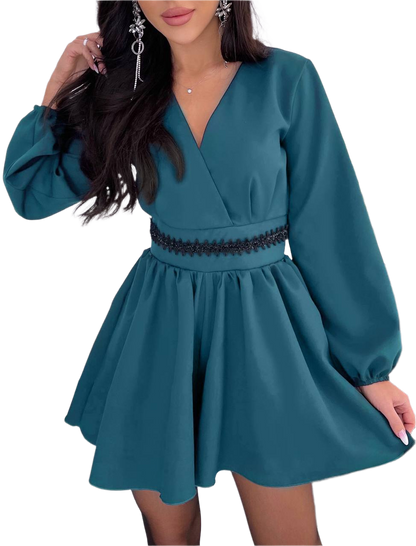 Teal dress with long sleeves on a white background