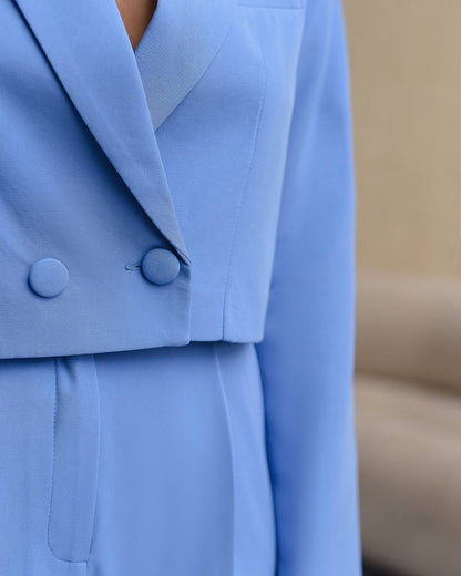 Close-up of a light blue blazer with buttons on a blurred background