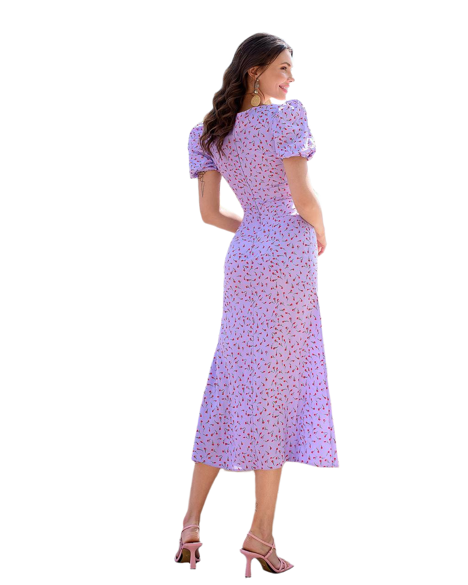 Woman wearing a purple floral dress on a white background
