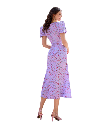 Woman wearing a purple floral dress on a white background