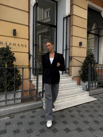 Person walking out of a building with 'BÓzhané' on the door.