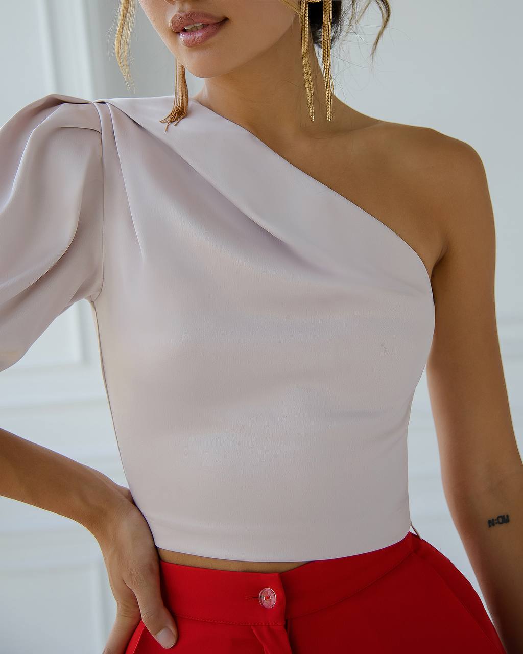One-shoulder top worn by a person with a blurred background