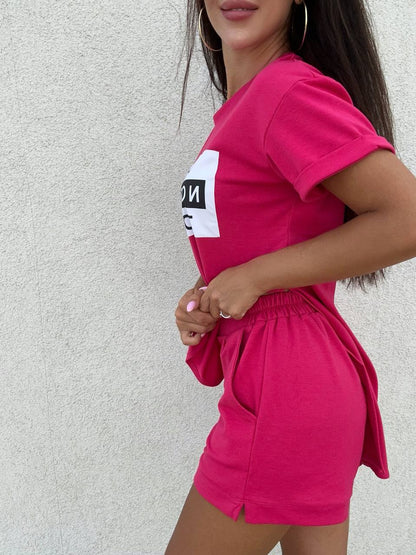 Woman wearing a bright pink outfit with a white background