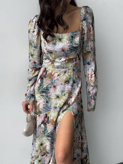 Floral dress with long sleeves and a slit on a plain background