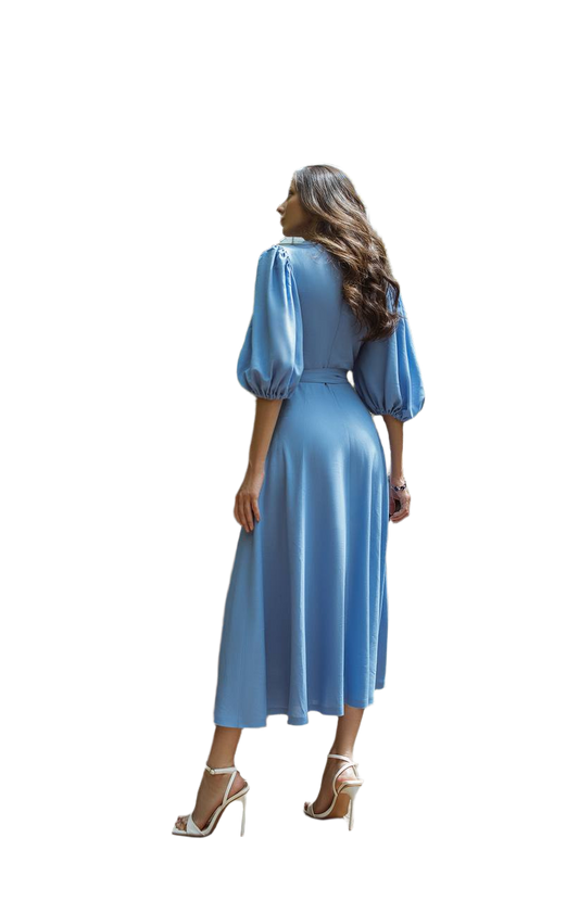 Woman wearing a blue dress with long sleeves on a white background