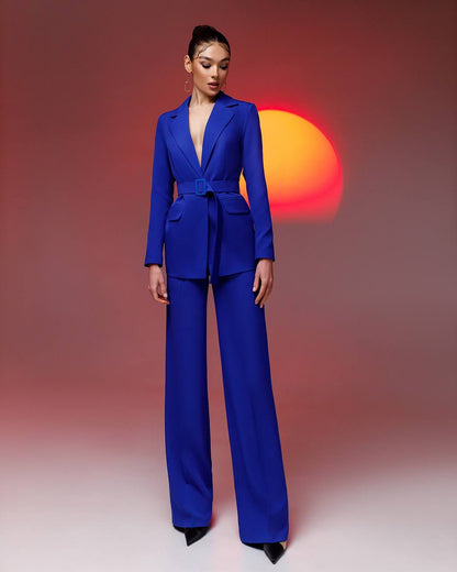 Woman wearing a blue suit with a colorful background