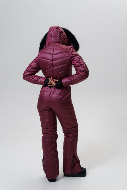 Person wearing a maroon puffer suit on a white background
