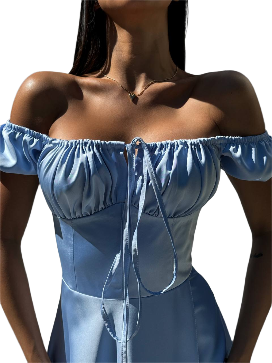 Blue off-shoulder top worn by a person on a white background