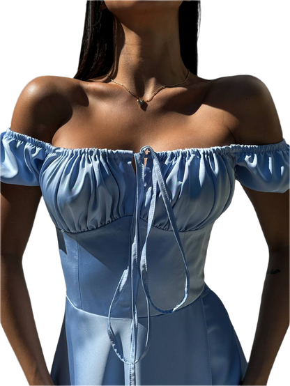 Blue off-shoulder top worn by a person on a white background