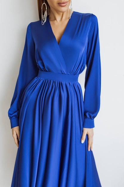 Blue dress worn by a model on a white background