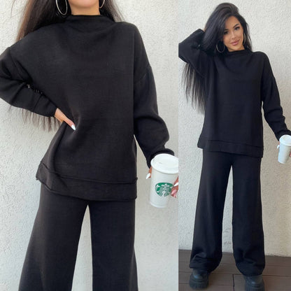 Woman wearing a black outfit holding a Starbucks cup against a neutral background