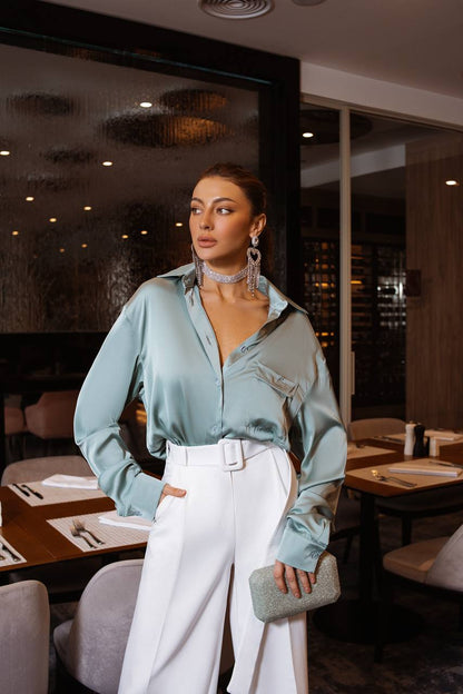 Woman in a stylish outfit standing in a restaurant setting