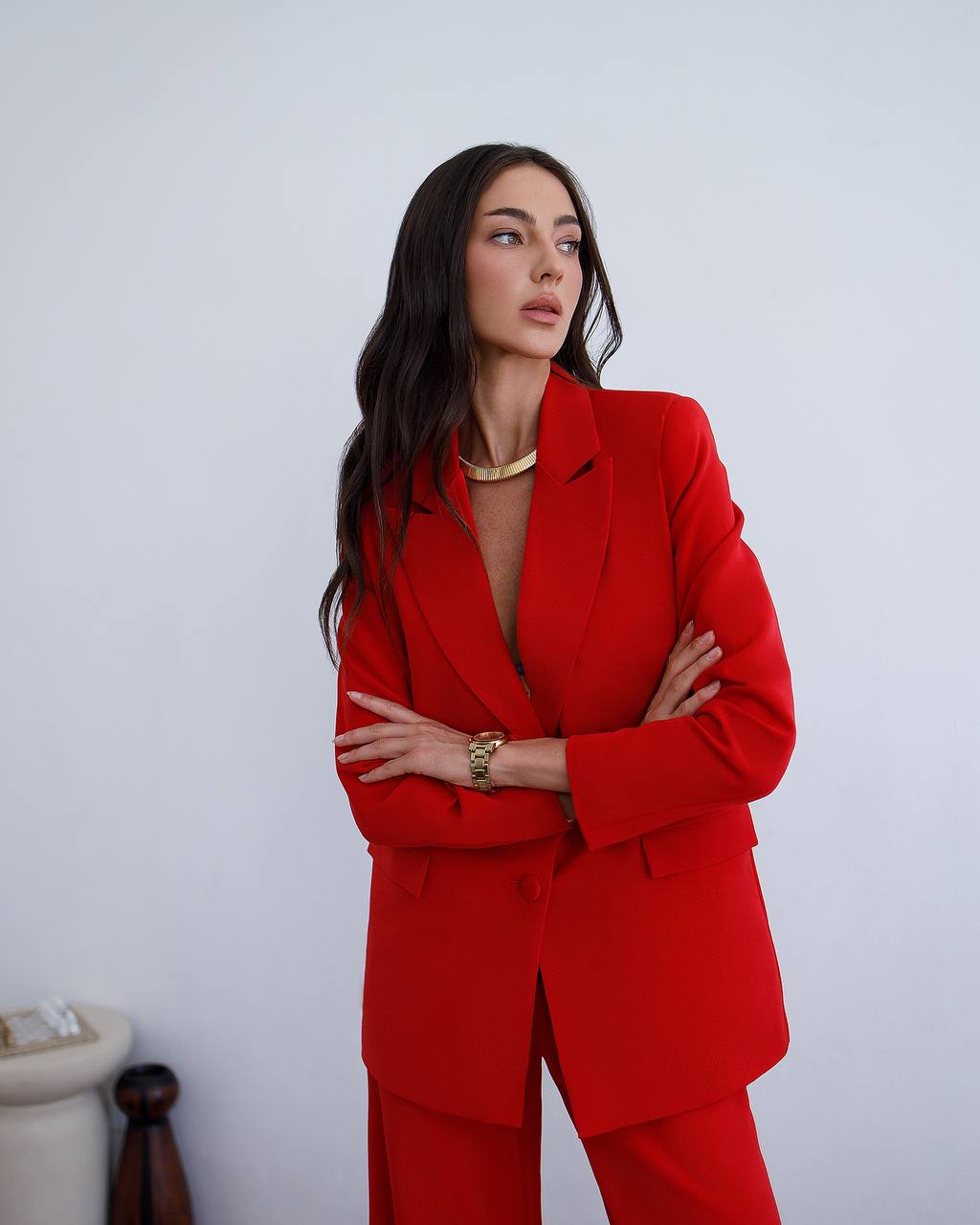 Woman wearing a red suit with a white background