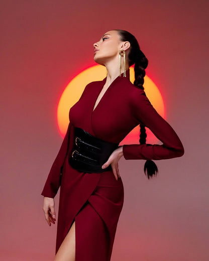 Woman in a red dress with a sun-like background