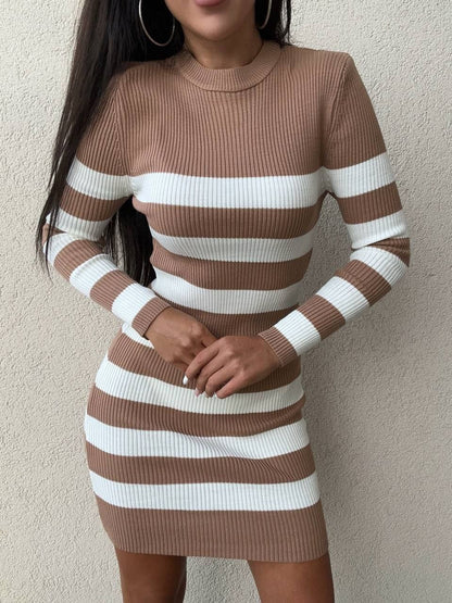 Brown and white striped dress worn by a person against a plain background