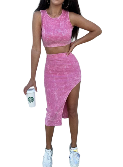 Woman wearing a pink matching set with a Starbucks cup on a white background