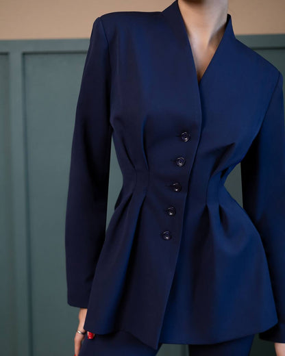 Navy blue blazer with button details on a neutral background
