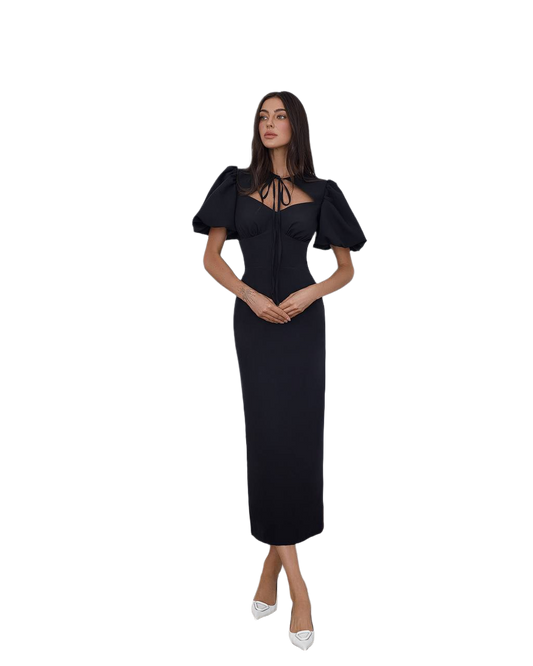 Woman wearing a black dress with puff sleeves on a white background