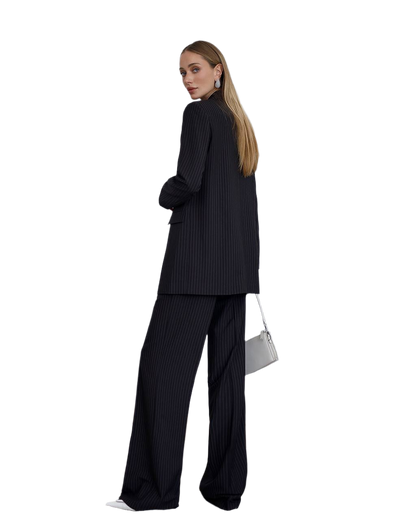 Woman wearing a black pinstripe suit with a white background