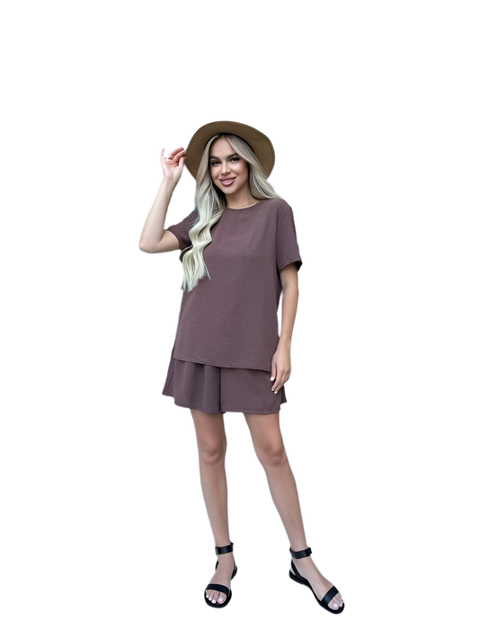 Woman wearing a brown outfit with a hat on a white background
