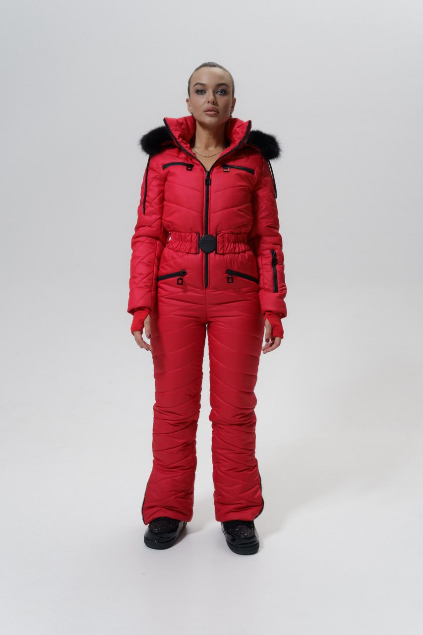 Person wearing a red puffer suit with black accents on a white background
