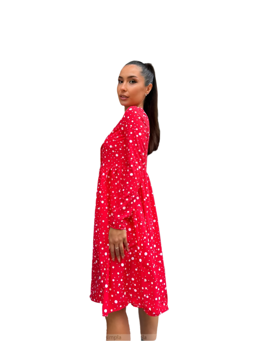 Woman wearing a red dress with white patterns on a white background