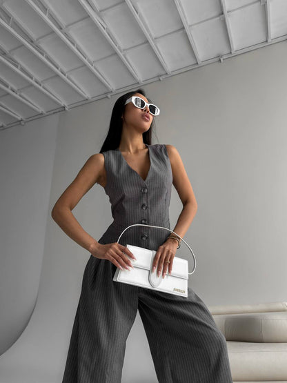 Woman holding a white handbag in a modern indoor setting