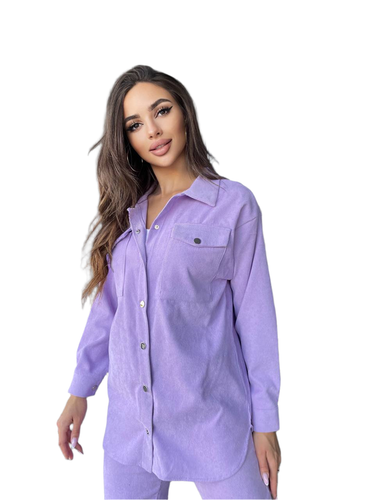 Woman wearing a light purple button-up shirt on a white background